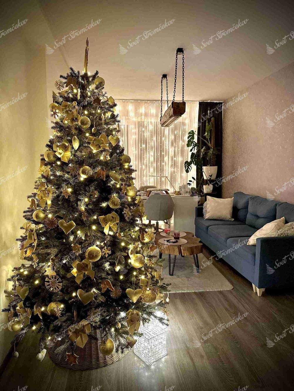 Umelý vianočný stromček 3D Smrek Alpský 210cm je ozdobený zlatými vianočnými ozdobami.